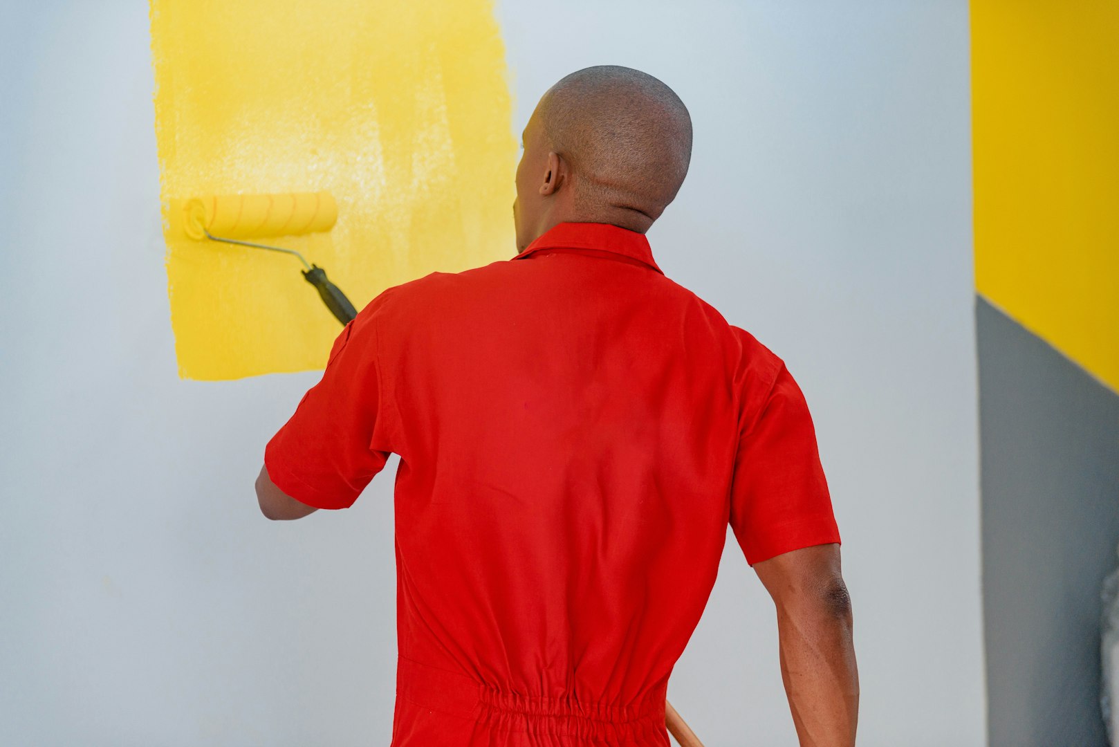 Construction worker installing luxury vinyl plank flooring using glue down method